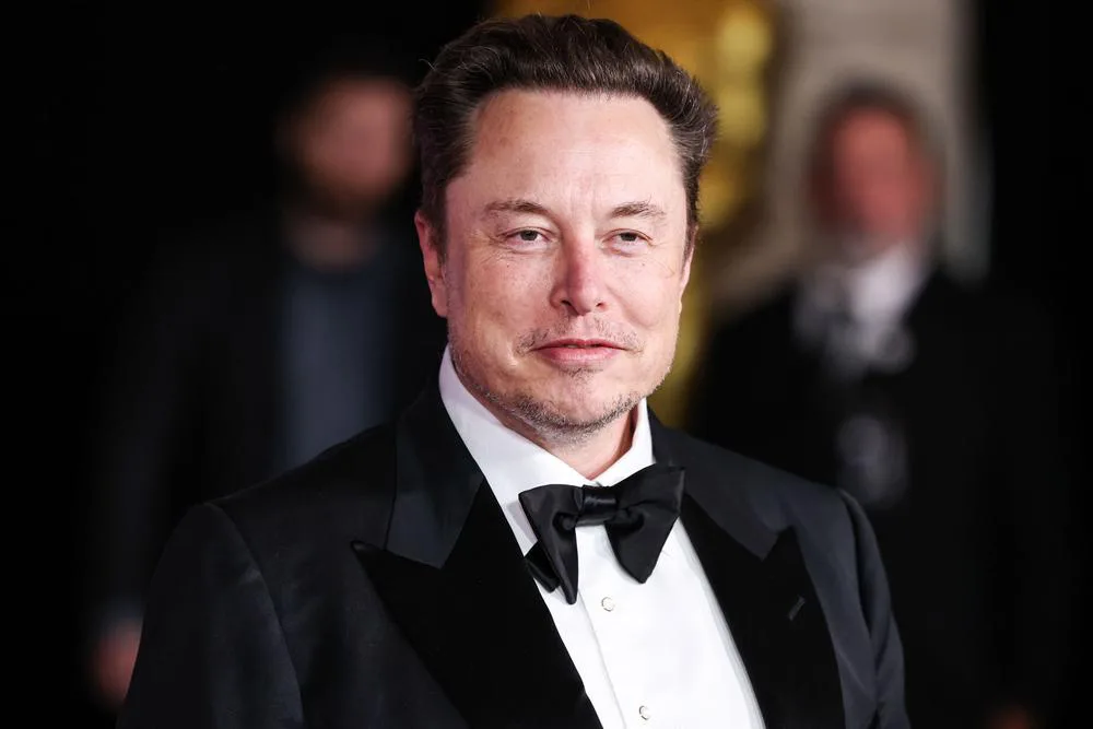 Elon Musk in a tuxedo at an event, showing the fuller hairline behind hair transplant speculation