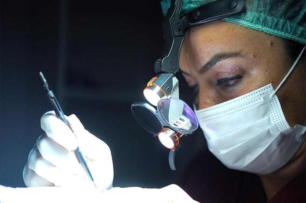 female technician performing fue hair transplant