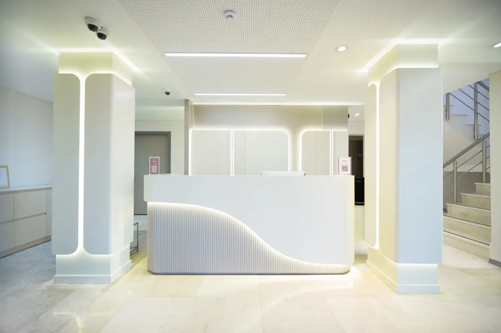 Hermest Clinic reception with its curved, backlit desk