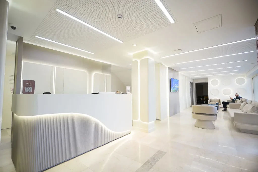 Consultation room with wooden panelling and a wall screen